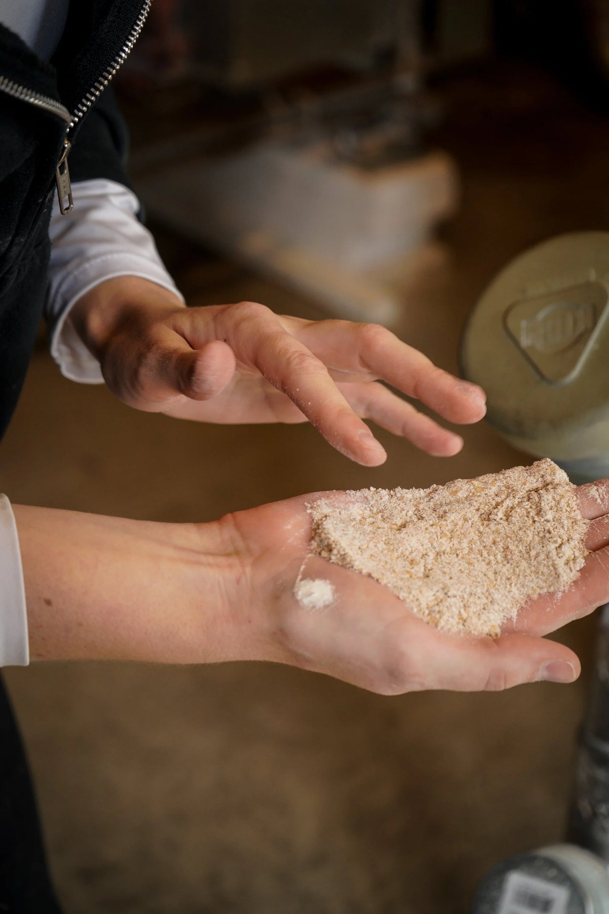 A handful of freshly milled flour at Farmer Ground Flour. Photo by Jane Walker.