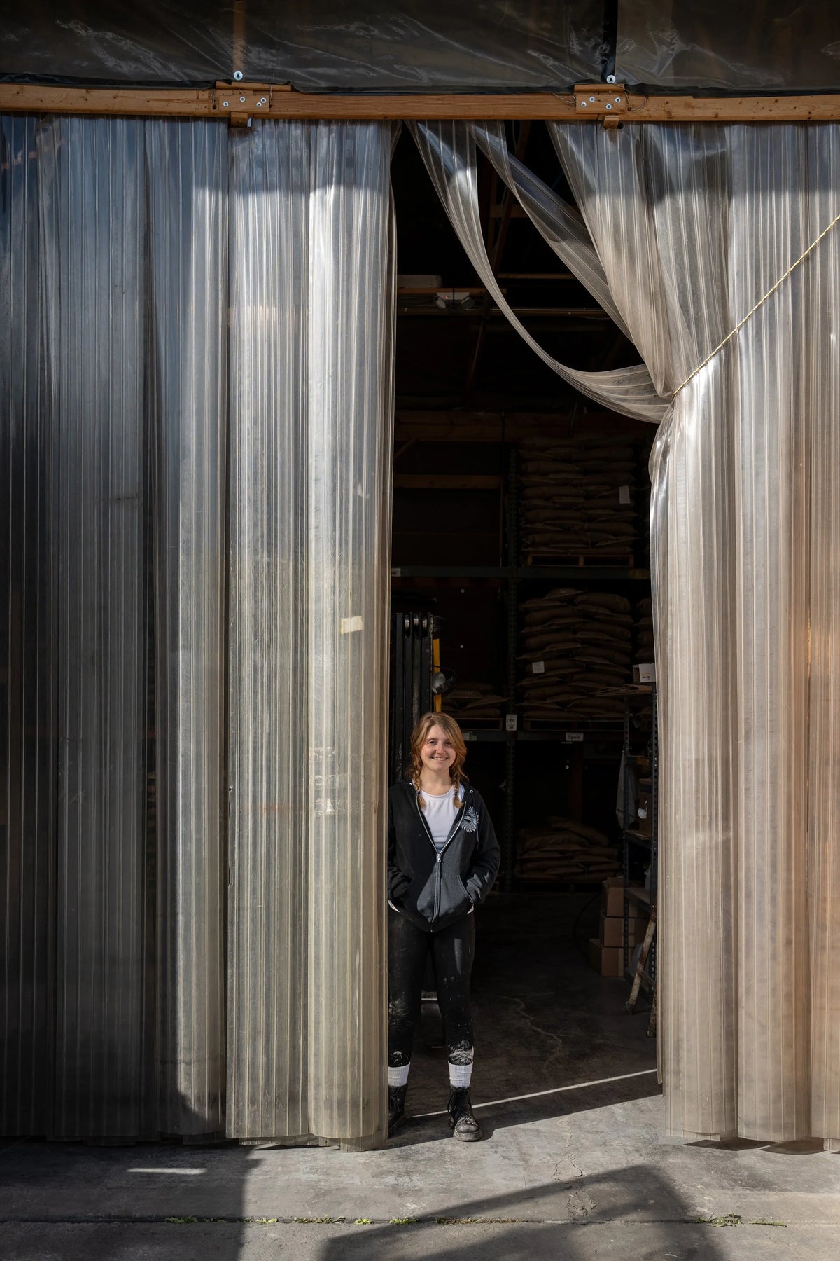 A miller in the doorway of the Farmer Ground Flour warehouse. Photo by Harry Littell.