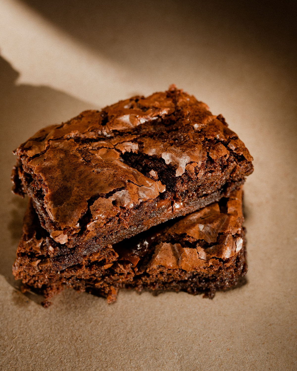 Fudgy chocolate brownies with a crackled top, stacked